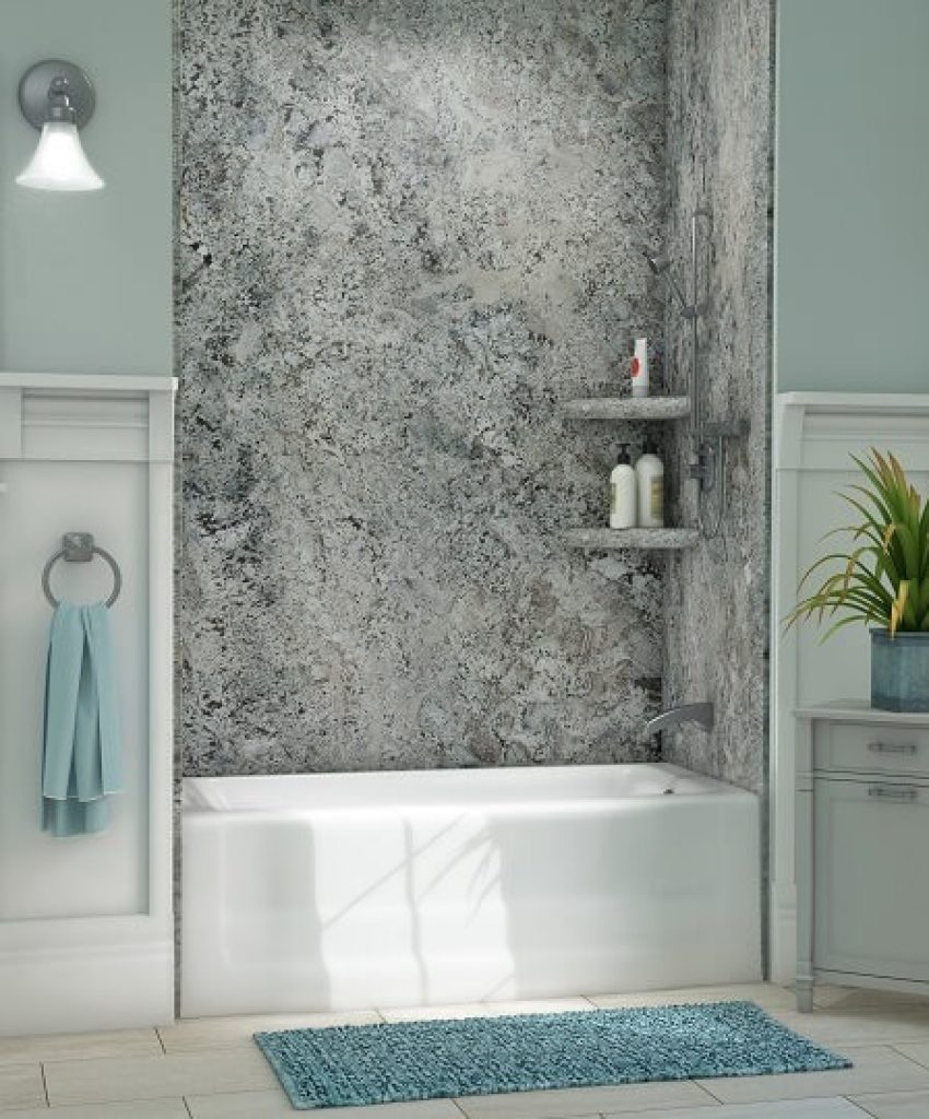 Modern bathroom with a marble accent wall and white bathtub.